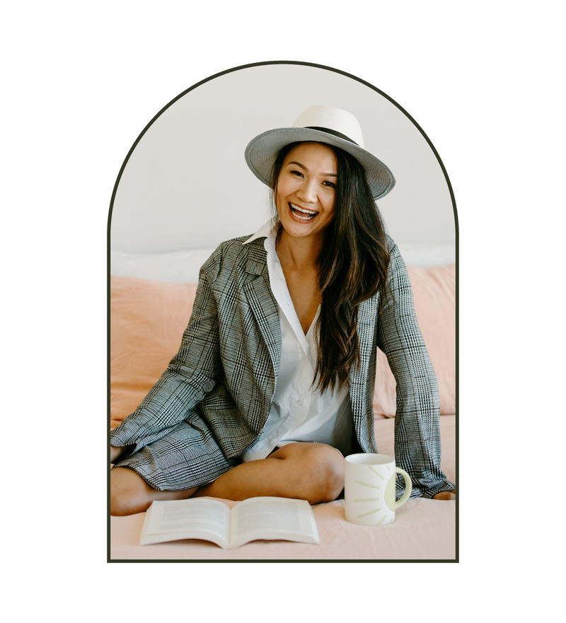 Woman wearing a Sol Authentica hat with a mug and book