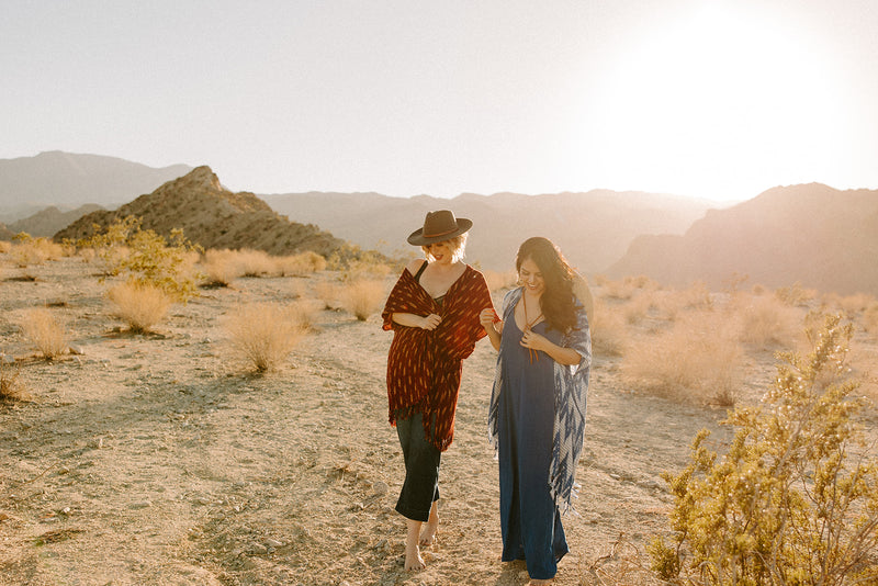 Two girls walking in the desert wearing Sol Authentica Kimonos