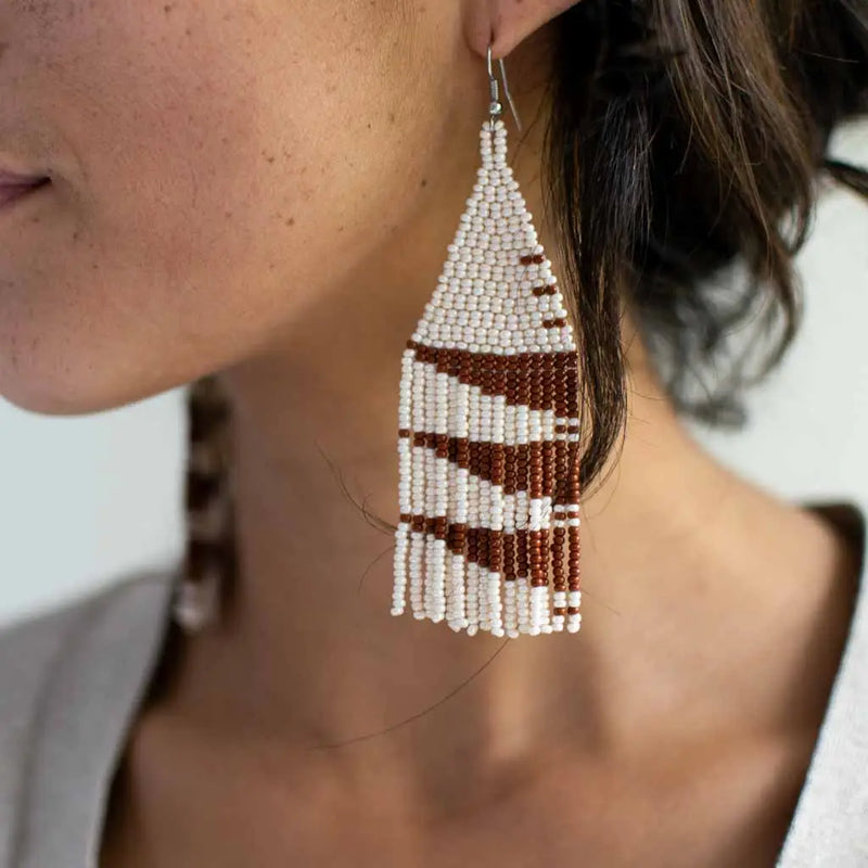 Artisan-crafted beaded fringe earrings in white and brown colors and styles